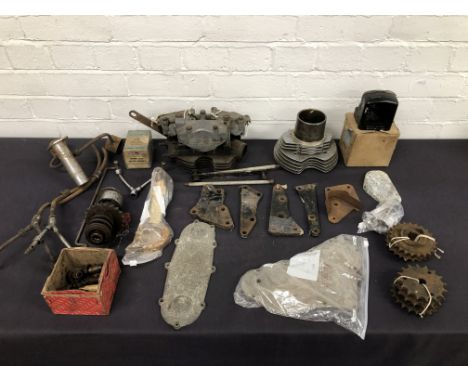 An assortment of mainly Velocette engine sparescomprising of cylinder barrels; pistons; valve guides; conrods; engine plates;