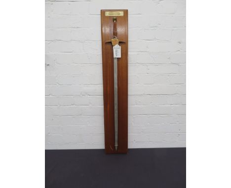 Offered from the estate of the late Percy Tait A Wilkinson Sword, awarded to P. H Taitmounted to wooden base with applied pla