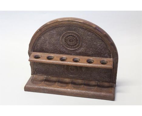 19th Century Indian pipe rack, carved with a foliate swirl design and hinged pipe holder, 29cm wide