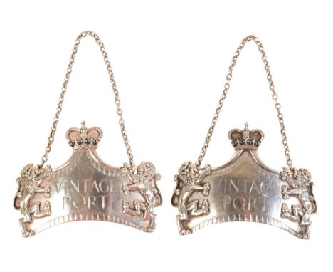 A PAIR OF SILVER PORT LABELS with embossed decoration of lions and a crown, by L.G.D. of London, circa 1974 (2)Proceeds are t
