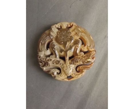 A Chinese pierced and carved jade pendant with mythical creature decoration, 2¼'' diameter