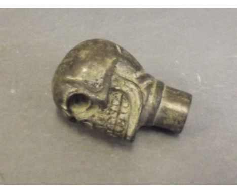 A bronze walking stick handle in the form of a skull, 3'' long