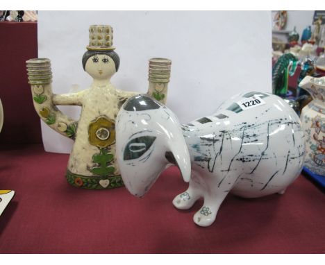 A XX Century Pottery Goat, with abstract decoration, (unmarked), together with continental candlestick. (2)