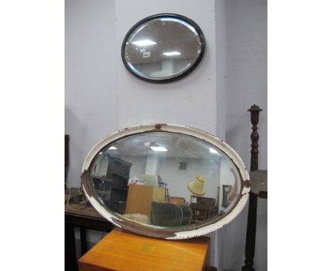 An Oval Bevelled Wall Mirror, in painted frame, stamped 'LNER', 42cm wide, Painted oak framed wall mirror, lager. (2)