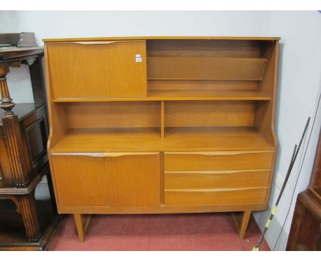 A Teak Lounge Unit, circa 1970's with upper fall cupboard door, open section over cupboard doors to left, three drawers to ri