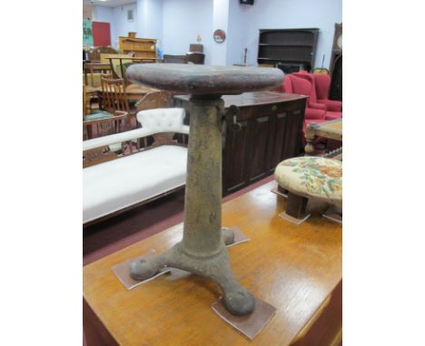 A Singer Cast Iron Sewing Machine Stool, tripod base with circular wooden top, and adjustable thumb screw action, stamped Sin