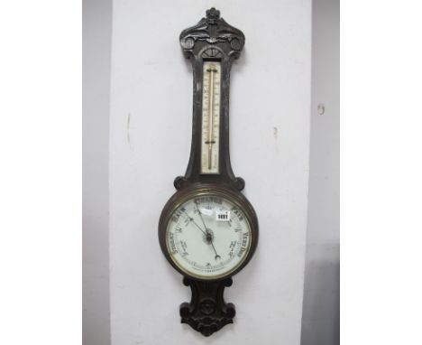An Early XX Century Carved Oak Two Dial Aneroid Barometer.