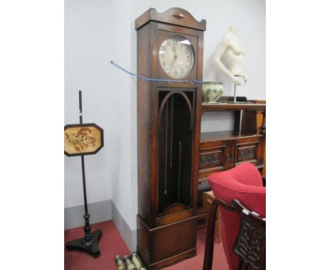 A 1920's Oak Eight Day Long case Clock, with circular dial, Arabic numbers, shaped base (no glass to door).