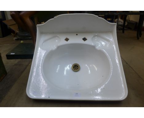 An early 20th Century cast iron wash basin, with brackets 