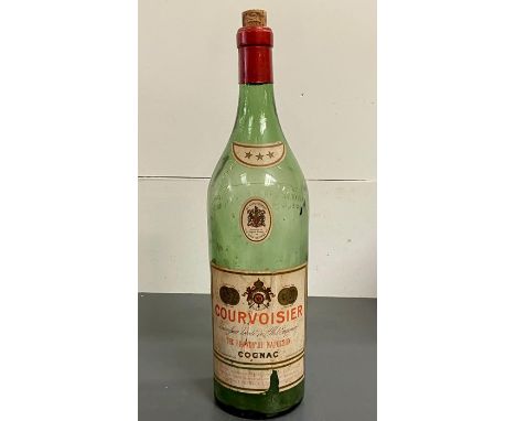 A large vintage cognac bottle by Courvoisier 