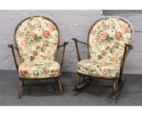 An Ercol spindle back rocking arm chair along with Ercol spindle back arm chair with floral seat and back covers.