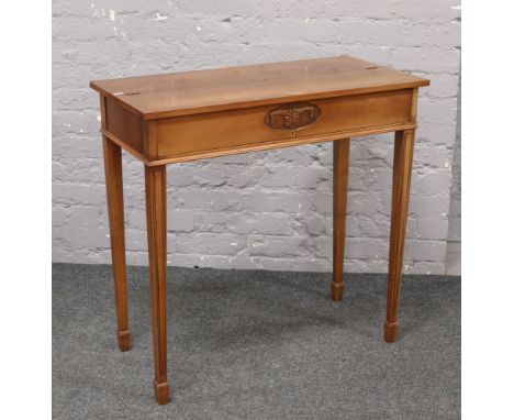 A Jaycee bur walnut metamorphic side table / writing desk with fitted interior and leather inlay, raised on tapering spade fo