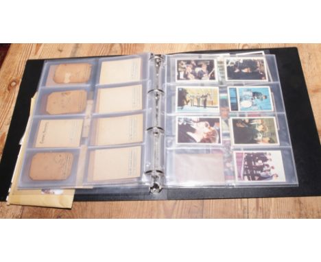 A folder of Beatles memorabilia including collectors cards, first day covers and photographs etc.