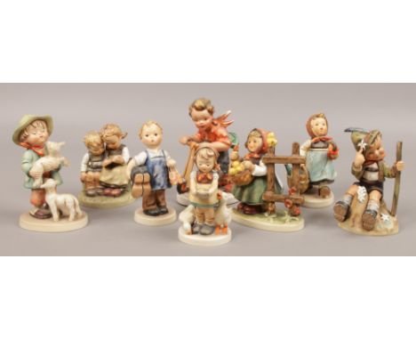 Eight Goebel figurines to include boy on shooter, boy holding sheep examples etc.