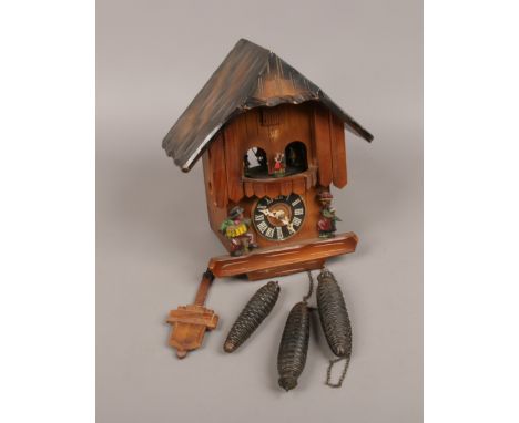 A German triple weight musical cuckoo clock with carousel of dancing figures.