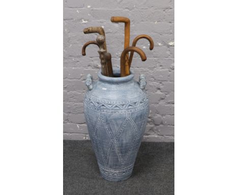 A large blue twin handle urn and seven walking sticks to include Deputies yard stick.