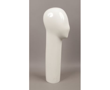 A minimalist shop mannequin head.