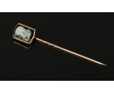 A cased 19th century gold and carved hardstone cameo stick pin with a portrait of a bearded man.&nbsp;