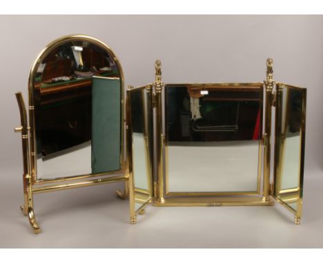 A good quality brass triple fold dressing table mirror with column support and seated lions along with a brass dome top bevel