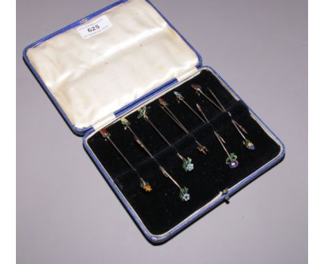 A case of ten silver and enamel toothpicks with floral terminals, assayed Birmingham 1933 one for 1932.Condition report inten