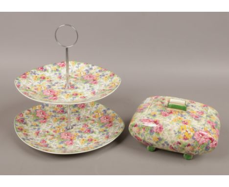 A Midwinter Chintz two tier cakestand and an Art Deco biscuit box decorated in the Springtime pattern.Condition report intend