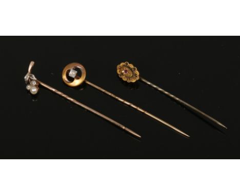 Three Victorian stick pins, ruby, diamond and pearl set, one formed as a fruit sprig.