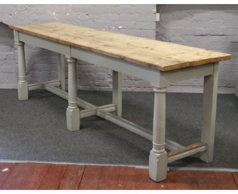 A large farmhouse plank top pine side table with painted base, raised on turned supports and with cross stretchers, 61.5cm x 