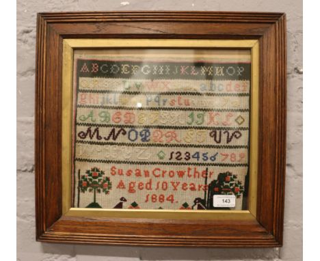 A framed Victorian sampler Susan Crowther aged 10 years 1884.