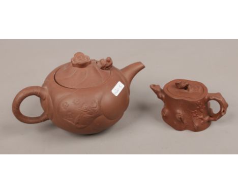 Two Chinese Yixing red stoneware teapots, smaller example with an impressed seal mark.