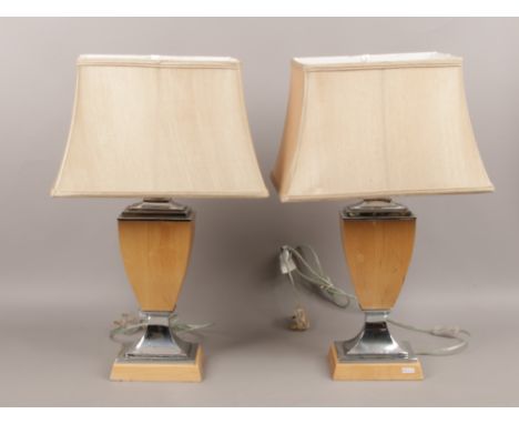 A pair of wood and chrome table lamps, height 66cm.