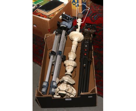 A plaster lamp base and two camera tripods.