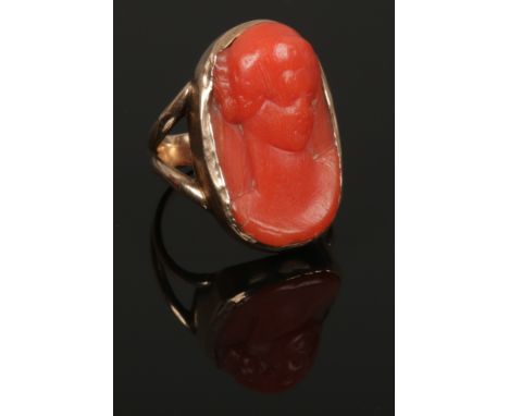 A Victorian 9ct gold ring set with a carved coral portrait of a lady. Size N.