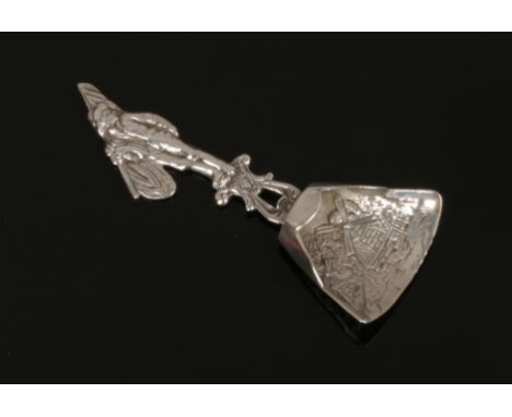 A continental silver caddy spoon with chased windmill decoration and the handle formed as a man.