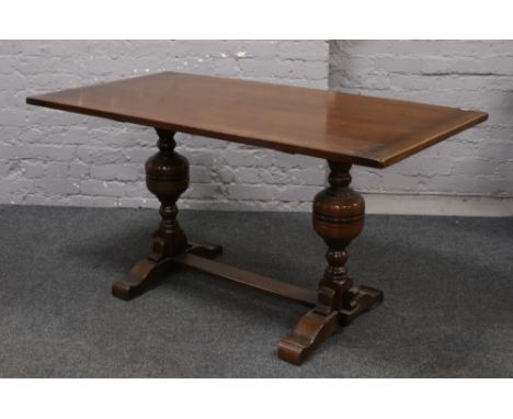 A carved oak refectory dining table raised on bulbous turned legs.