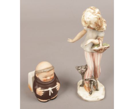 A Goebel figure of a young girl and cat, along with a Goebel monk.