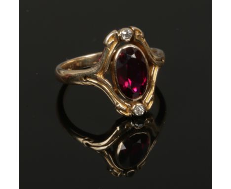 A vintage 14ct gold ring set with a large synthetic ruby and two diamonds. Size I.