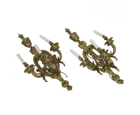 Pair of brass Neoclassical style three branch electric light wall sconces, decorated with a lidded urn with flame finial abov