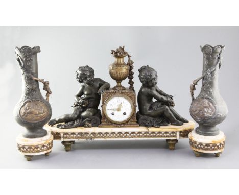 A French Art Nouveau bronzed spelter and marble three piece clock garniture, clock 20in.