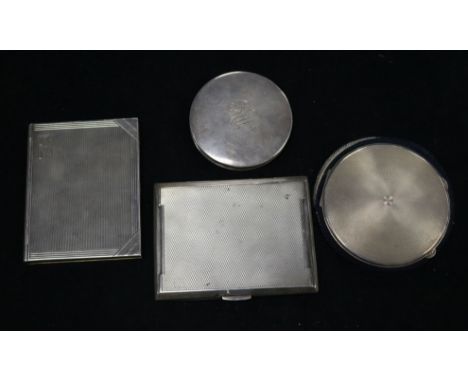Two silver compacts and two engine turned silver cigarette cases including one modelled as a book.