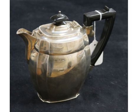 A silver teapot, of oval canted form with ebonised handle and finial, Chester 1936, S Blanckensee & Son Ltd, 16.4oz