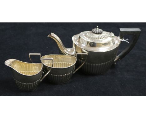 A three-piece silver tea service of oval half-fluted form, Birmingham 1897, John Millward Banks