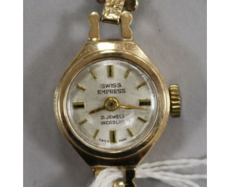 A lady's 9ct gold Swiss Empire manual wind wrist watch on a 9ct gold bracelet.