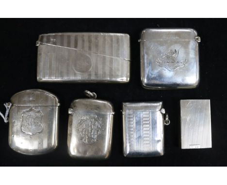 Two engine-turned silver vesta cases, a similar card case, two initialled and crested vestas and a pillbox holder, total 6.6o