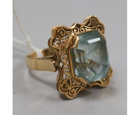 A yellow metal and fancy cut aquamarine set dress ring, size R