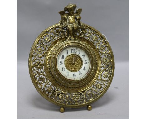 A brass putti mantel clock