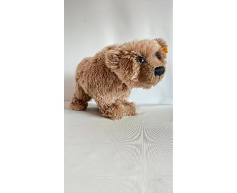 Steiff "Grizzly" bear plush, featuring signature "Knopf im Ohr" button and yellow tag, made in Germany.