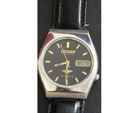 Mid size Citizen Automatic watch features a black dial with day and date display, 21 jewels, stainless steel case, and a blac