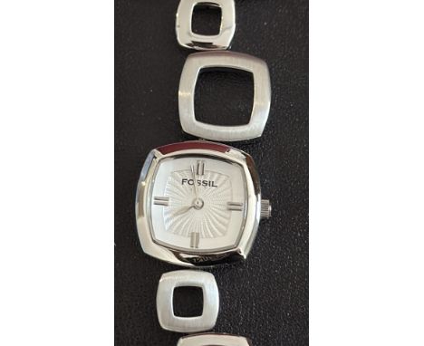 Ladies Fossil watch with square silver case and white dial, featuring geometric link bracelet. Not currently ticking, possibl