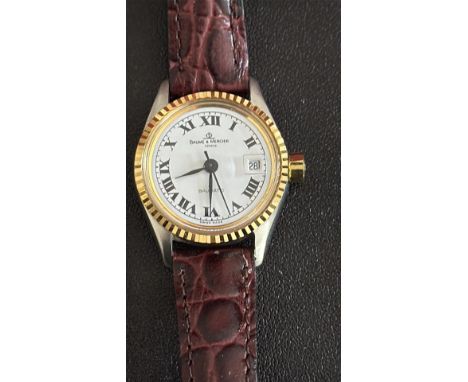 Ladies Baume & Mercier Genève automatic watch features a gold and stainless steel case, Roman numerals, and a date at 3 o'clo