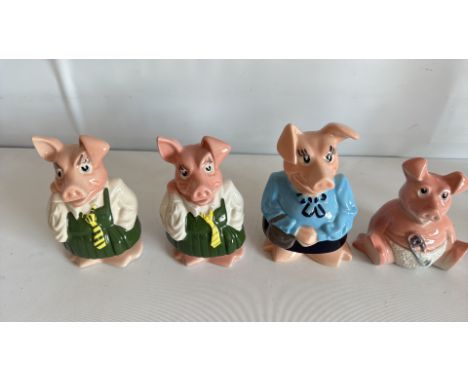 Set of four Wade England ceramic pig figurines, each dressed in different attire.